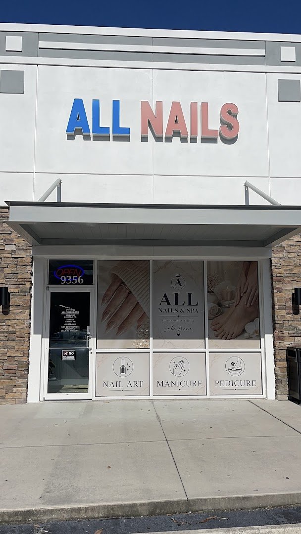 Clean nail salon stations with manicure tools.